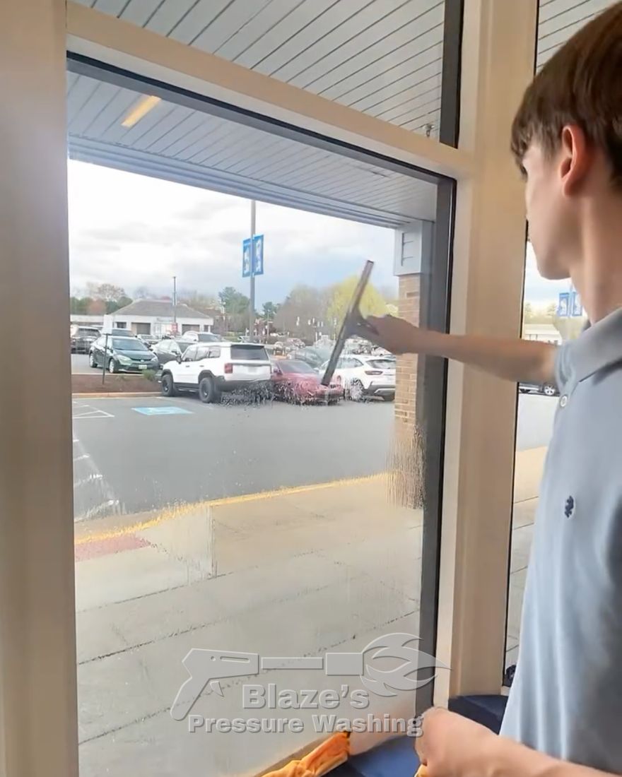 Storefront window being squeegeed clean
